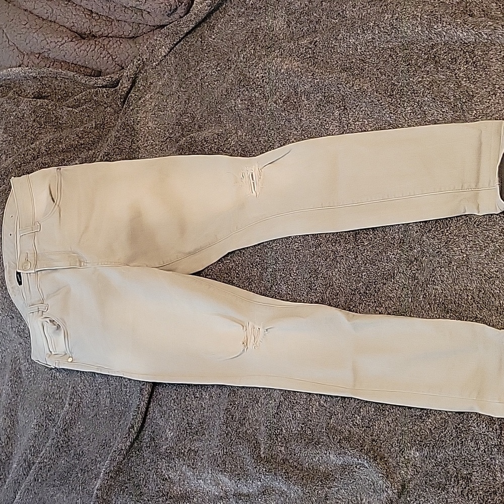 Light gray skinny jeans with distressed knees